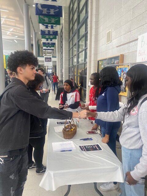 A picture of students interacting at an event.